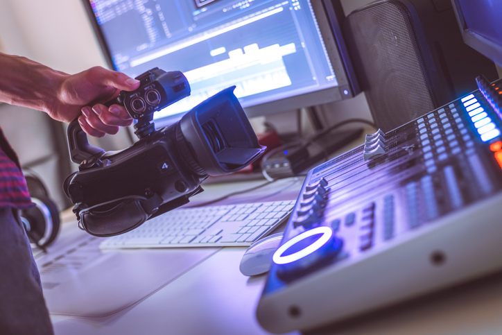 Video editing, recording and cutting room with monitors, camera and sound mixing desk