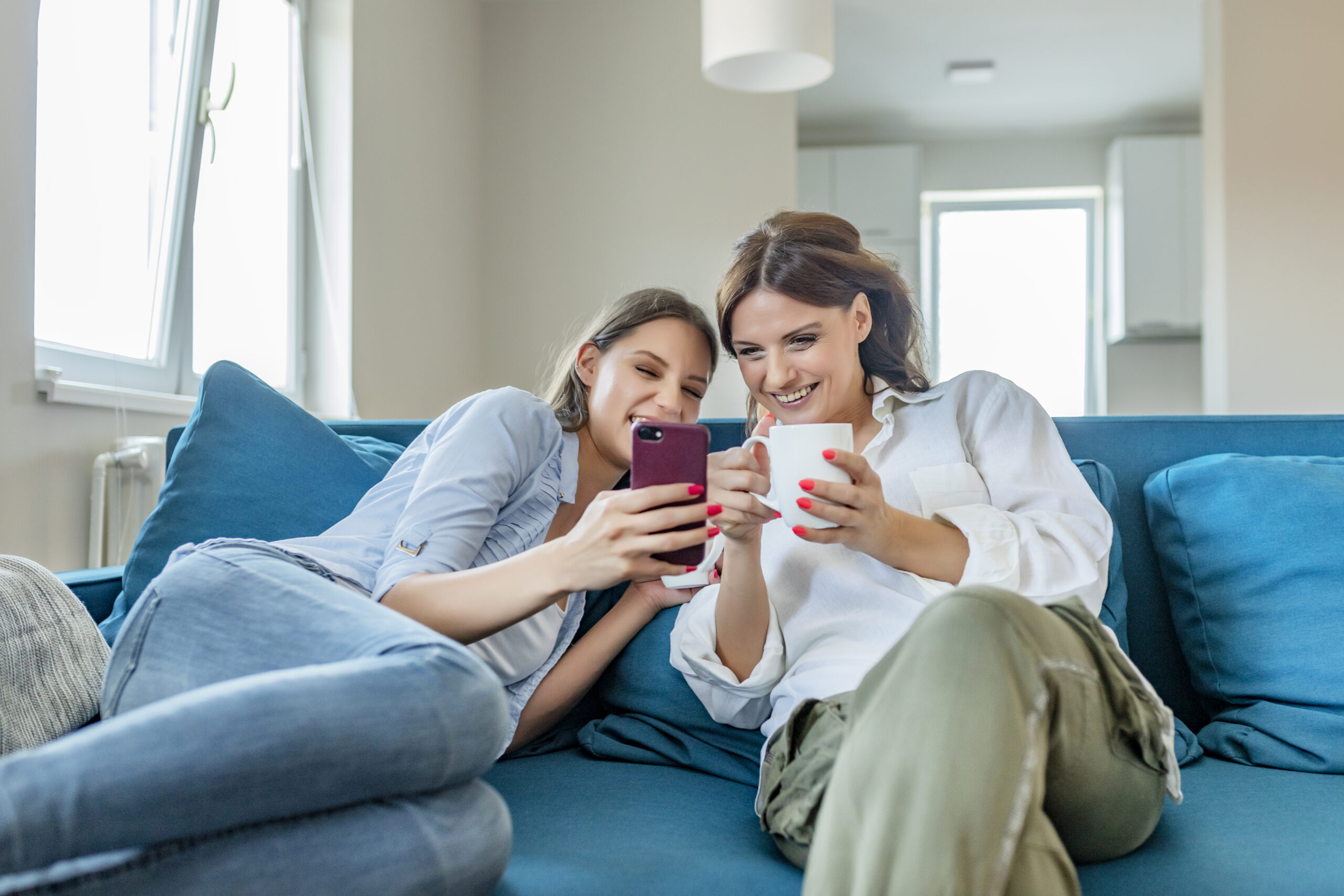Mother and daughter using a phone